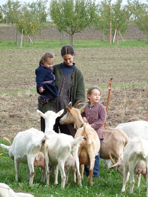 Mother with children and goats