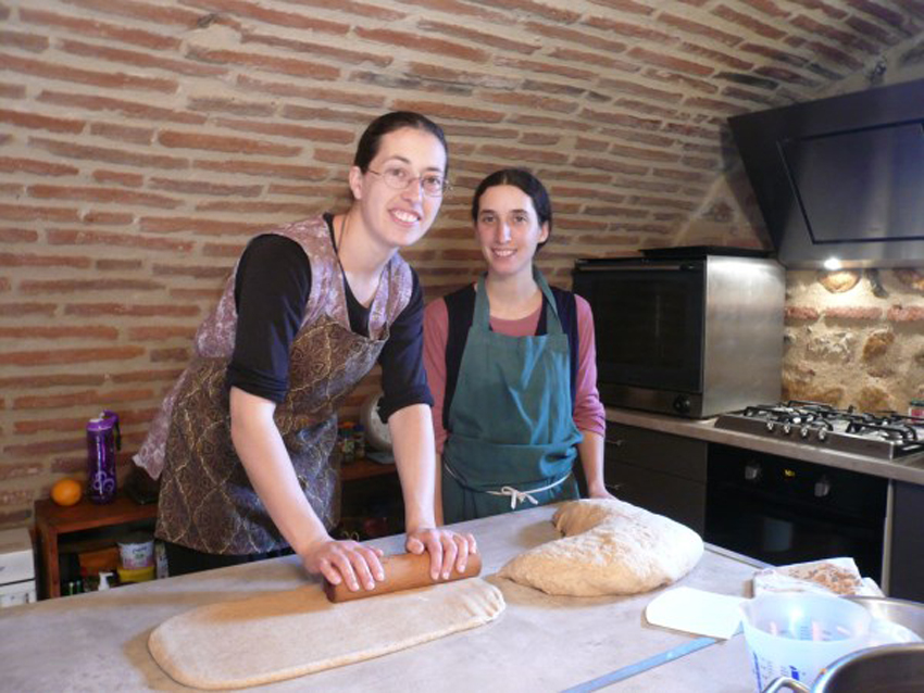 Two of the sisters making bread